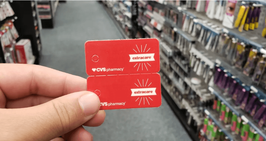 hand holding two red coupons